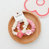 A pair of lily hair rings