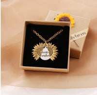 A gold necklace with a box