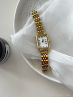 Gold Strap White Surface